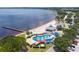 Aerial view of community beach with playground, splashpad and pier on the lake at 16615 Oklahoma St, Clermont, FL 34715