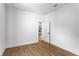 A bright bedroom featuring light-colored wood flooring and neutral color palette at 16615 Oklahoma St, Clermont, FL 34715