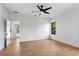 Bright bedroom featuring light-colored wood flooring, a modern ceiling fan, and a neutral color palette at 16615 Oklahoma St, Clermont, FL 34715