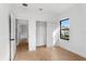 Bright bedroom features wood floors, closet, and window view at 16615 Oklahoma St, Clermont, FL 34715