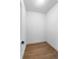 Empty closet featuring wood-look flooring and a door at 16615 Oklahoma St, Clermont, FL 34715