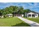 Exterior view of renovated home featuring a large 2-car garage at 16615 Oklahoma St, Clermont, FL 34715
