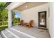Covered front porch has chairs and table and welcomes visitors at 16615 Oklahoma St, Clermont, FL 34715