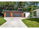 Detached garage with two bays features a wood and black metal exterior at 16615 Oklahoma St, Clermont, FL 34715