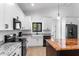 Close up of kitchen featuring white cabinets, granite countertops, and stainless steel appliances at 16615 Oklahoma St, Clermont, FL 34715