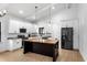 Kitchen featuring white cabinets, a black island with a wood top, and stainless steel appliances at 16615 Oklahoma St, Clermont, FL 34715