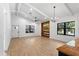 Spacious living room featuring wood-look floors, fireplace, a TV, and bright windows at 16615 Oklahoma St, Clermont, FL 34715