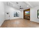 Bright and airy living room features wood floors, a ceiling fan, and a fireplace with a mounted TV at 16615 Oklahoma St, Clermont, FL 34715