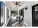 Cozy porch area with white shiplap walls, dark wood flooring, and black trim windows at 16615 Oklahoma St, Clermont, FL 34715