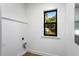 Bright room with white walls and trim featuring a window with a pleasant green outdoor view at 16615 Oklahoma St, Clermont, FL 34715