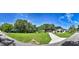 Street view of large grassy lot with mature trees between the house and detached garage at 16615 Oklahoma St, Clermont, FL 34715