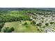 Aerial view displays the property's proximity to nearby community houses, green spaces, and natural surroundings at 1702 Hoofprint Ct, Fruitland Park, FL 34731