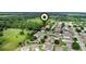 Aerial view pinpoints the property within a neighborhood setting near green spaces and community amenities at 1702 Hoofprint Ct, Fruitland Park, FL 34731