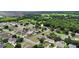 Aerial shot shows the property surrounded by neighborhood residences and picturesque scenery, emphasizing community living and natural beauty at 1702 Hoofprint Ct, Fruitland Park, FL 34731