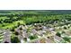 Aerial shot reveals the property nestled in a residential area, complemented by lush landscaping and natural surroundings at 1702 Hoofprint Ct, Fruitland Park, FL 34731