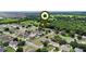 Aerial view showcases the property positioned amongst neighborhood homes, revealing its community setting and surroundings at 1702 Hoofprint Ct, Fruitland Park, FL 34731