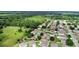 Aerial view captures the property amidst neighborhood homes and green spaces, showcasing community living at 1702 Hoofprint Ct, Fruitland Park, FL 34731