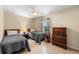 Neutral bedroom featuring two twin beds, matching dressers and a ceiling fan for added comfort at 1702 Hoofprint Ct, Fruitland Park, FL 34731
