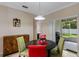 Dining area with table that seats four, leading to a screened outdoor space with grill at 1702 Hoofprint Ct, Fruitland Park, FL 34731