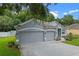 Charming home featuring a three-car garage, well-maintained landscaping, and inviting curb appeal at 1702 Hoofprint Ct, Fruitland Park, FL 34731