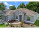Attractive single-story home with manicured landscaping, a well-kept lawn and a welcoming entrance at 1702 Hoofprint Ct, Fruitland Park, FL 34731