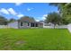 View of the home's backyard showcasing the exterior features and landscaping at 1702 Hoofprint Ct, Fruitland Park, FL 34731