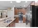 Spacious kitchen boasting stone countertops, stainless steel appliances, and a seamless view to the living room at 1702 Hoofprint Ct, Fruitland Park, FL 34731