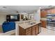 Open kitchen with a breakfast bar, stainless steel appliances, and seamless flow into the living area at 1702 Hoofprint Ct, Fruitland Park, FL 34731
