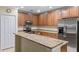 Bright kitchen featuring stone countertops, stainless steel appliances, and plenty of cabinet space at 1702 Hoofprint Ct, Fruitland Park, FL 34731