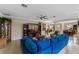 Spacious living room with tile floors, crown molding, and a comfortable blue sofa at 1702 Hoofprint Ct, Fruitland Park, FL 34731