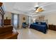 Relaxing main bedroom with tray ceiling, fan, and blue decor at 1702 Hoofprint Ct, Fruitland Park, FL 34731