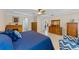 Comfortable main bedroom with wooden furniture and a connecting door to the kitchen at 1702 Hoofprint Ct, Fruitland Park, FL 34731