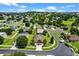 The aerial view shows the property surrounded by lush landscaping in a peaceful neighborhood setting at 1892 Sanderling Dr, Clermont, FL 34711