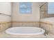 Elegant bathroom with a soaking tub and an abundance of natural light at 1892 Sanderling Dr, Clermont, FL 34711