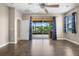 Bedroom with dark hardwood floors, a ceiling fan, and sliding glass doors to the pool area at 1892 Sanderling Dr, Clermont, FL 34711