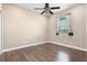 Cozy bedroom features hardwood floors, a ceiling fan, and a window that allows natural light at 1892 Sanderling Dr, Clermont, FL 34711