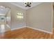 Bright dining room featuring hardwood floors, modern lighting and neutral wall paint at 1892 Sanderling Dr, Clermont, FL 34711