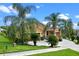Lovely landscaped home boasting a well-manicured lawn, mature palms, and stone accents at 1892 Sanderling Dr, Clermont, FL 34711