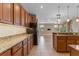 Open layout kitchen with granite counters, wood cabinetry and breakfast bar overlooking living area at 1892 Sanderling Dr, Clermont, FL 34711