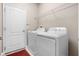Laundry room equipped with washer, dryer, and storage shelf, making chores a breeze at 1892 Sanderling Dr, Clermont, FL 34711