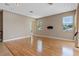 Living room with hardwood floors, neutral wall color and natural light from multiple windows at 1892 Sanderling Dr, Clermont, FL 34711