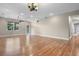 Spacious living room with hardwood floors, a ceiling fan, and access to the outside patio at 1892 Sanderling Dr, Clermont, FL 34711