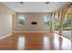 Expansive living room featuring hardwood floors, neutral walls, and sliding door access to the patio at 1892 Sanderling Dr, Clermont, FL 34711
