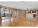 Bright open-concept living space with hardwood floors and access to a screened-in patio at 1892 Sanderling Dr, Clermont, FL 34711