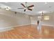 Spacious living room with hardwood floors, a ceiling fan, and open access to other rooms at 1892 Sanderling Dr, Clermont, FL 34711