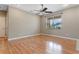 This bright living room features laminate floors, ceiling fan and neutral wall paint at 1892 Sanderling Dr, Clermont, FL 34711