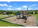 A colorful community playground features climbing structures, slides, and other recreational elements at 1892 Sanderling Dr, Clermont, FL 34711