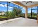A spacious screened-in porch provides an outdoor living area with views of the surrounding landscape at 1892 Sanderling Dr, Clermont, FL 34711