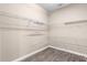 Walk-in closet provides ample storage, complemented by sleek wood flooring for a stylish space at 1892 Sanderling Dr, Clermont, FL 34711