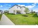 A large, well-maintained backyard featuring a covered patio and lush green lawn at 2161 Gold Dust Dr, Minneola, FL 34715